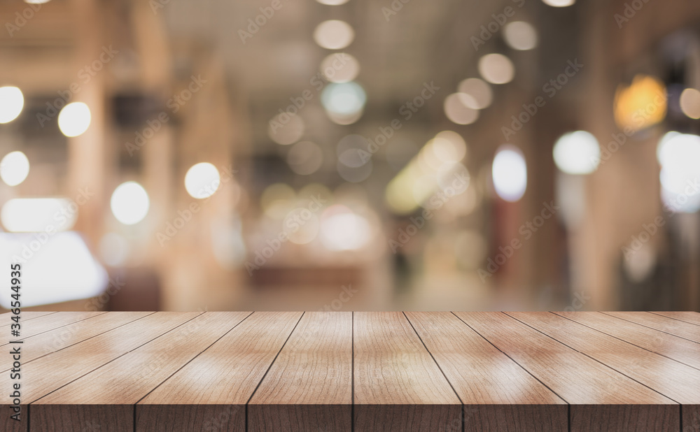 Wooden top table with bokeh light effect and blur restaurant on background, blur background.