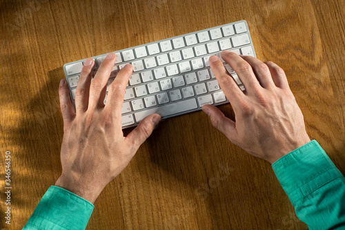 men's hands type on the keyboard