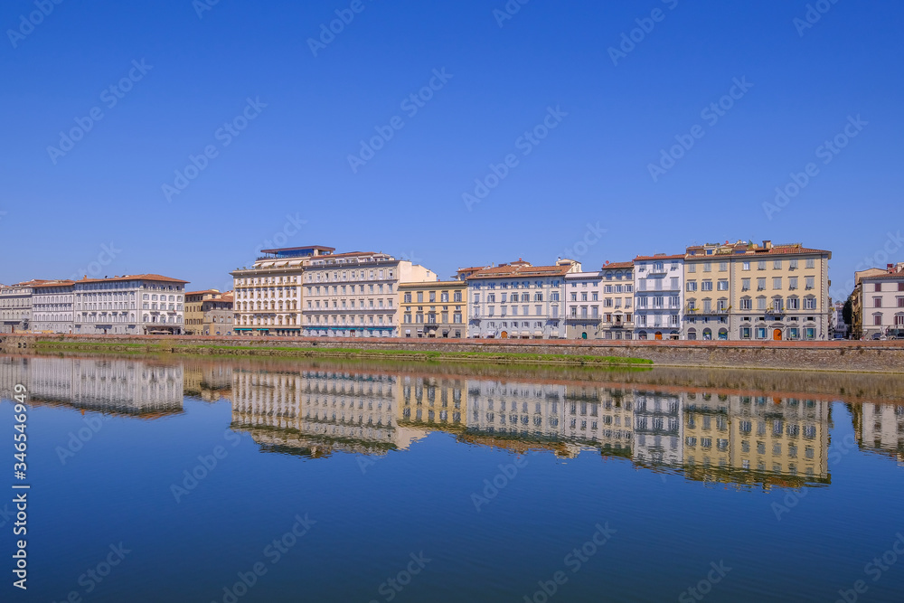 Fototapeta premium City houses with reflections in the Arno River, Florence, Tuscany, Italy