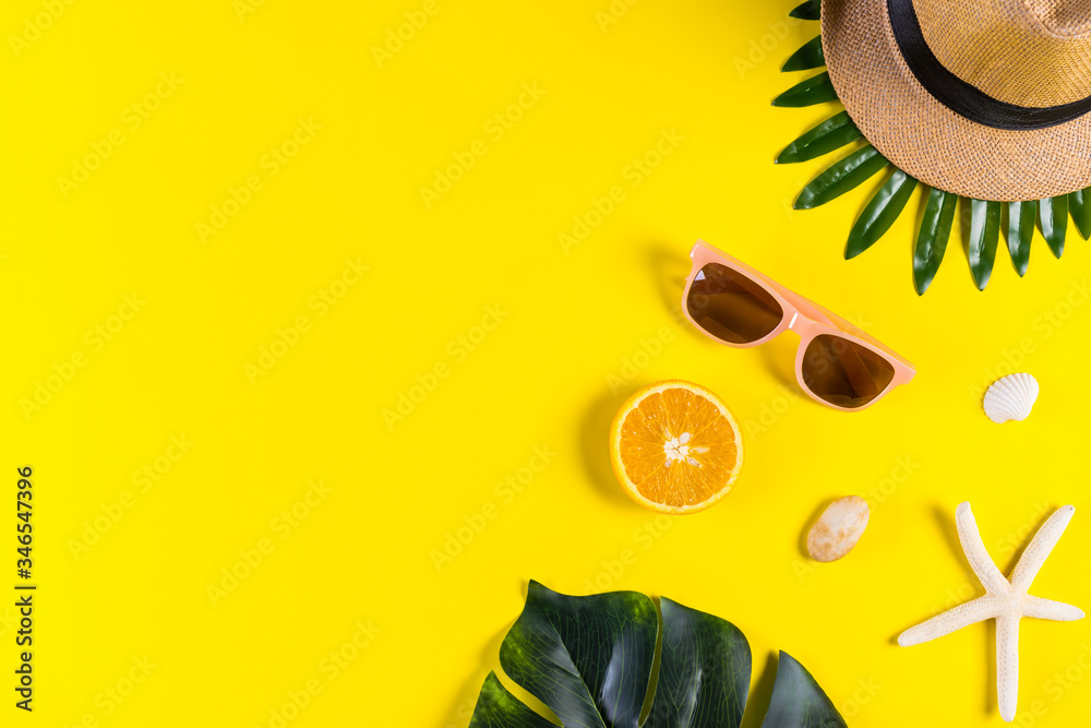 Summer background. Palm leafs with starfish and seashell on yellow background. Travel. Copy space