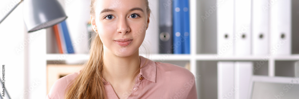 Girl in office on background folders and books Girl in office on background folders and books
