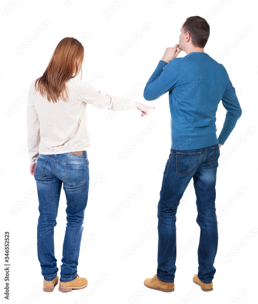Back view of couple in sweater pointing. Back view of couple in sweater pointing.