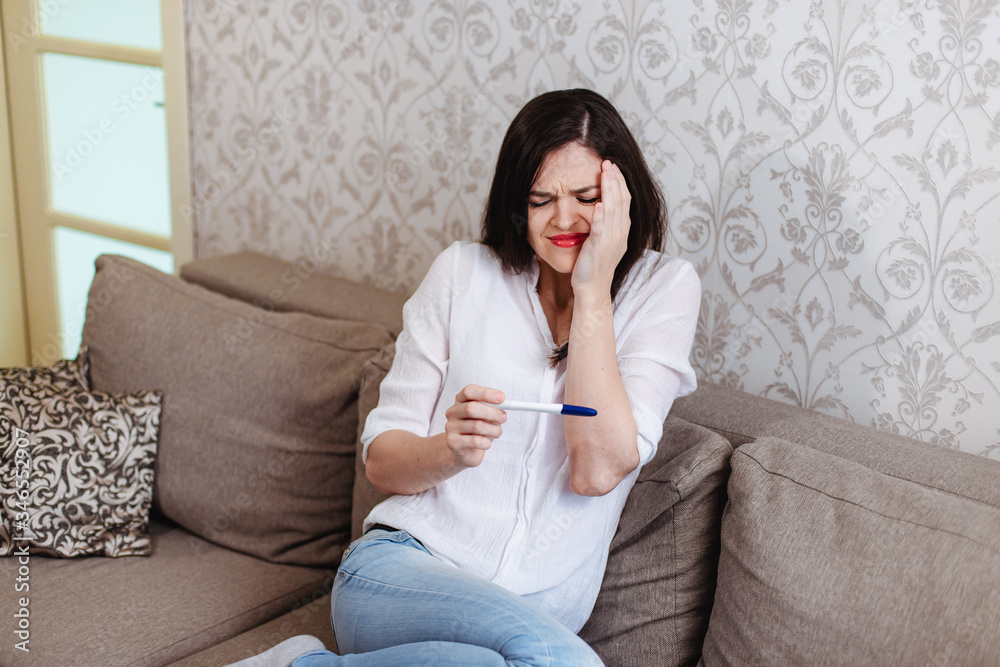 Young woman shocked to see a positive pregnancy test Young woman shocked to see a positive pregnancy test