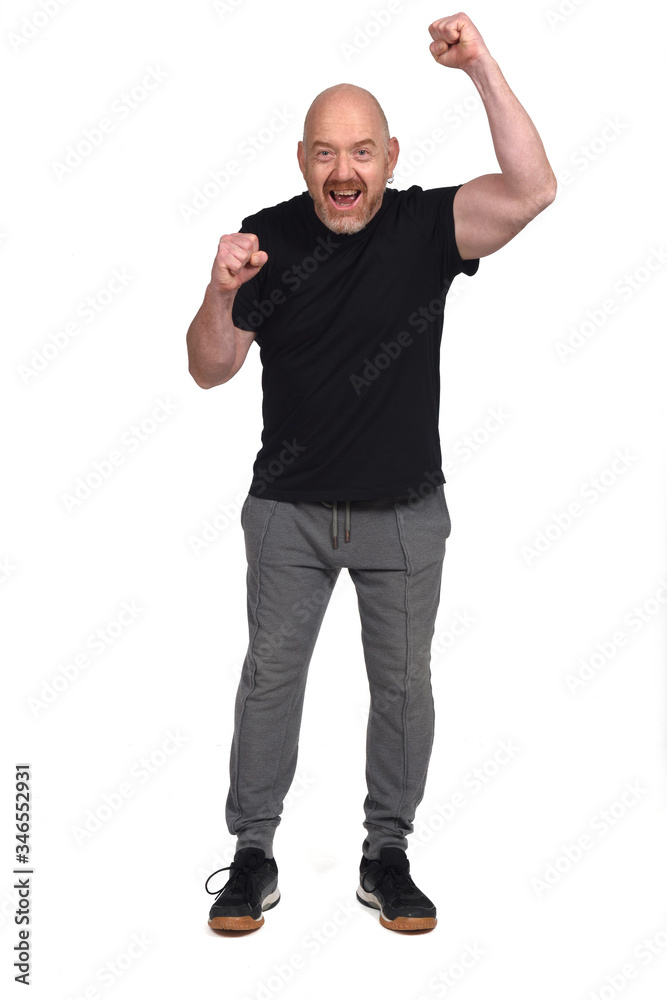 man with sportswear with fist raised on white background man with sportswear with fist raised on white background