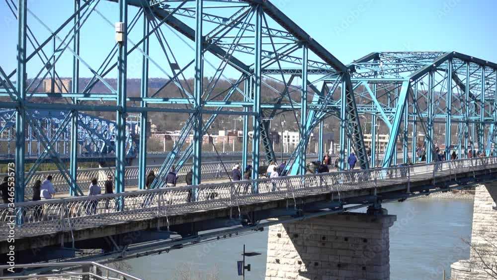 Small Groups Of People Crossing Footbridge With Room For Cars Traffic Environmentally Friendly Over Water Small Groups Of People Crossing Footbridge With Room For Cars Traffic Environmentally Friendly Over Water