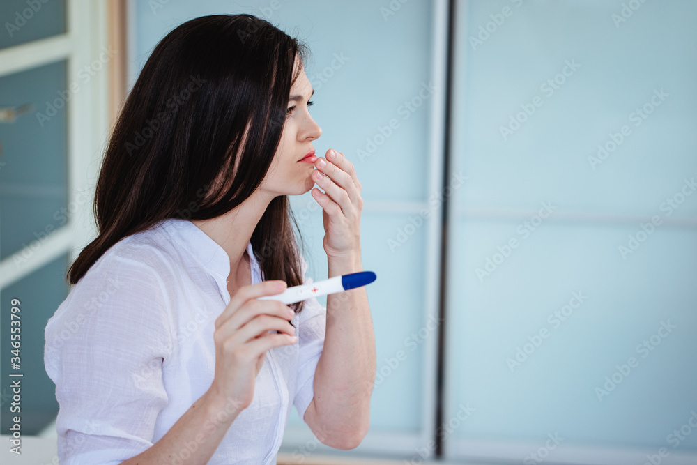 Young woman shocked to see a positive pregnancy test Young woman shocked to see a positive pregnancy test
