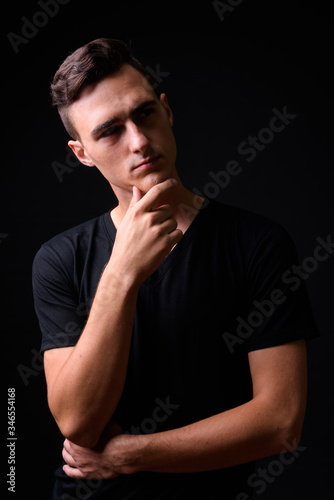 Portrait of stressed young man thinking and looking away