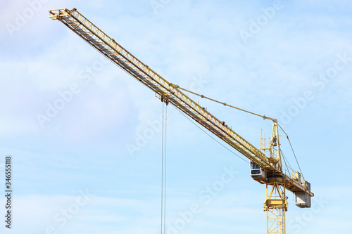 Construction crane works on site, street view
