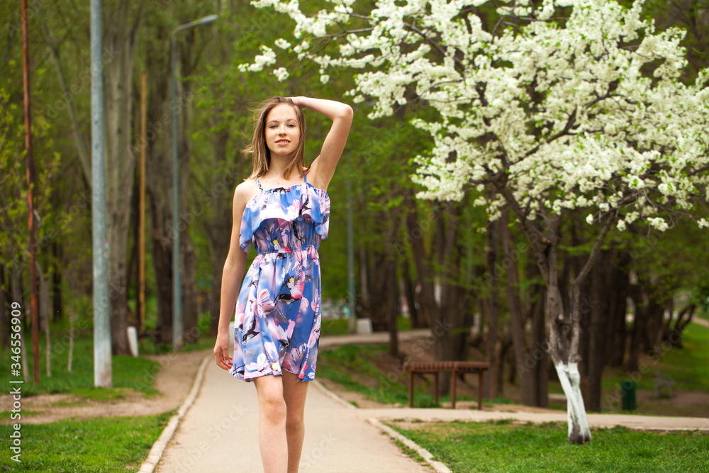 Portrait of a young blonde girl posing in spring park Portrait of a young blonde girl posing in spring park