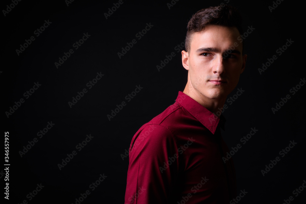 Fototapeta premium Portrait of young handsome businessman thinking and looking up
