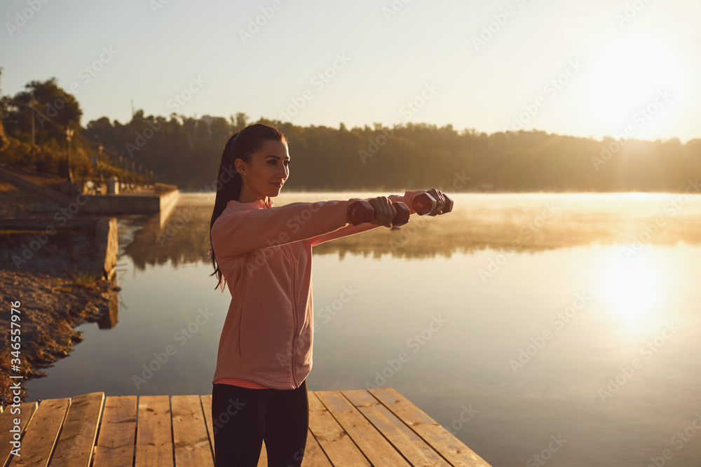 Workout exercises sport health by the lake in the morning. Workout exercises sport health by the lake in the morning.