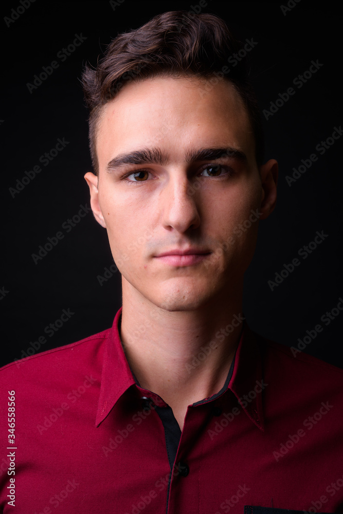 Fototapeta premium Portrait of young handsome businessman looking at camera