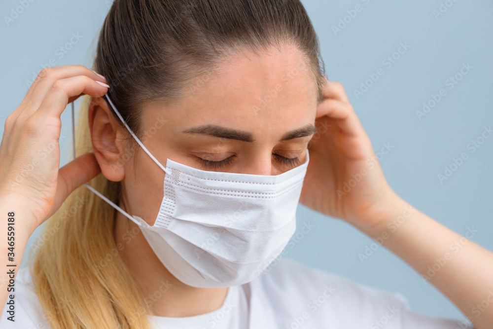 Instruction, how to wear the medical protective mask. Girl wears medical mask. Step 3. Instruction, how to wear the medical protective mask. Girl wears medical mask. Step 3.