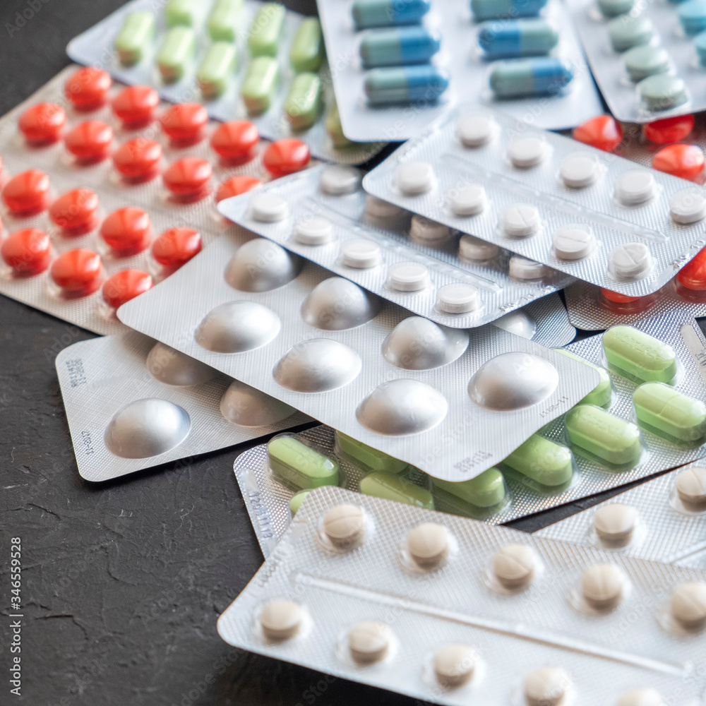 Different pills on dark background. Stop Covid-19 concept Different pills on dark background. Stop Covid-19 concept