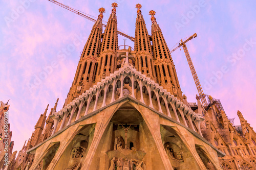 Sagrada Familia - A close-up wide-angle view of the west Passion facade of The Basílica de la Sagrada Família, against colorful Autumn sunset sky. Barcelona, Catalonia, Spain.