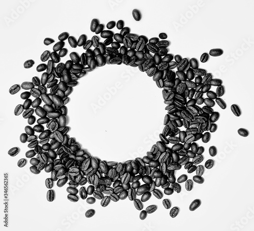 Circle frame of roasted brown coffee beans isolated on white background may use as background or texture.