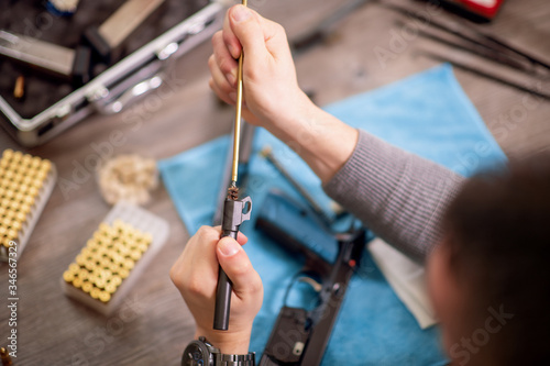 Man cleaning gun