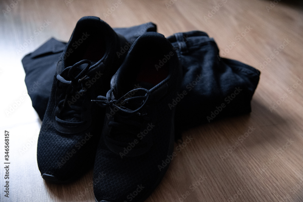 Black sneakers and black clothing. Black sneakers and black clothing.