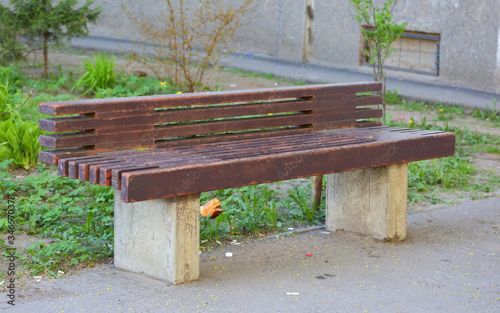 Street brown bench made of wood and concrete Street brown bench made of wood and concrete