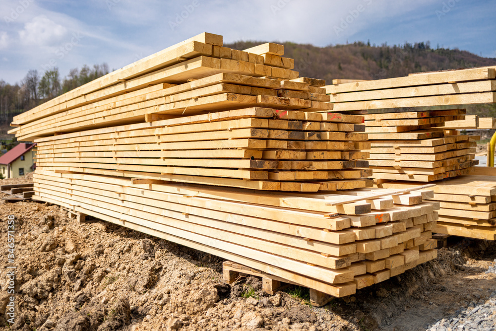 Stack of lumber wooden beams prepared to build a house Stack of lumber wooden beams prepared to build a house