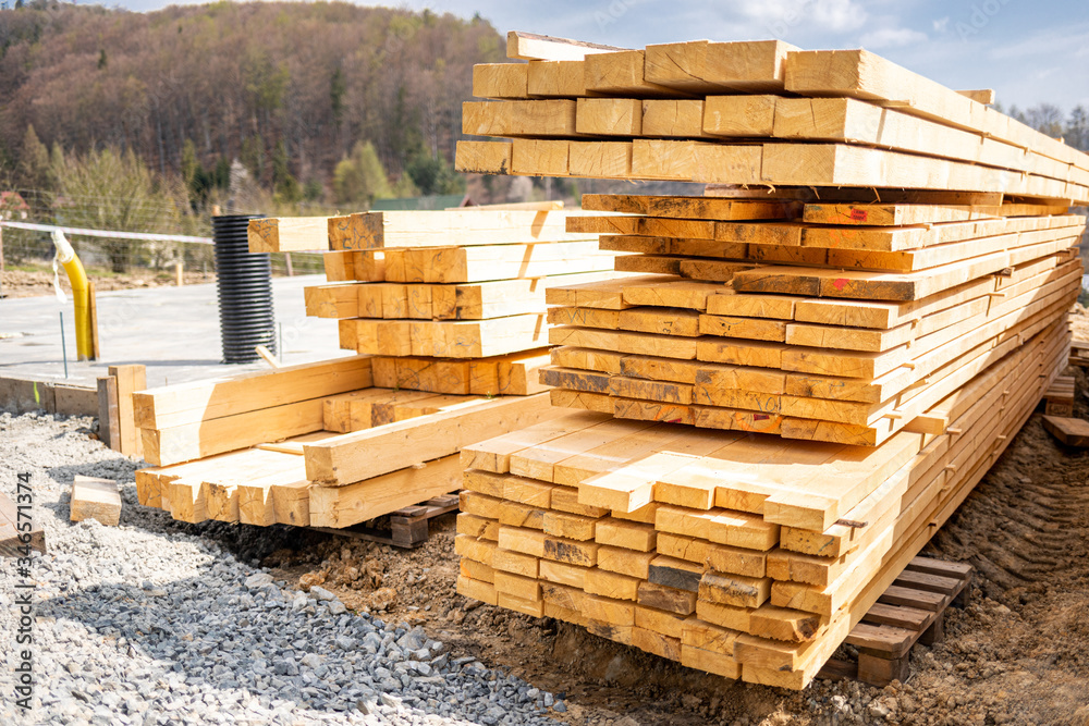 Stack of lumber wooden beams prepared to build a house Stack of lumber wooden beams prepared to build a house