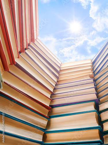Large books pile and bright...