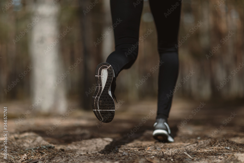 running in the woods. Girl is engaged in sports in the pine forest. running in the woods. Girl is engaged in sports in the pine forest.