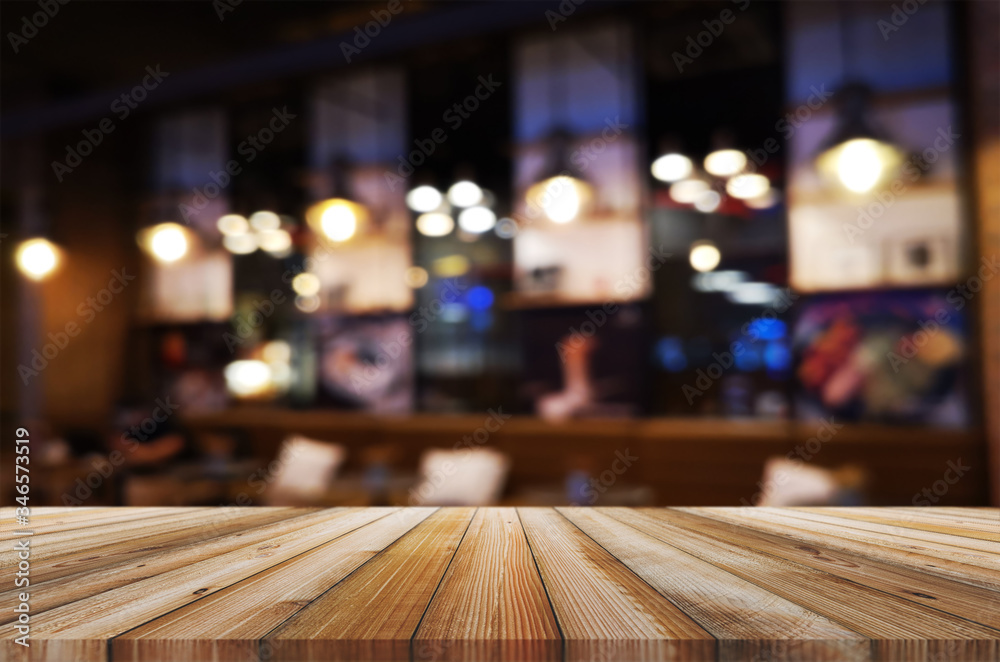 wooden table with abstract blurred background resturant lights used for display montage products mock up design.