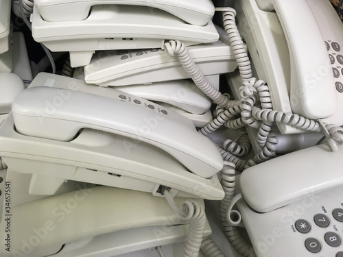 Close up of unused white telephones waiting for scrapping