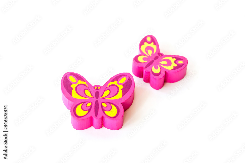 Fototapeta premium Wooden figure for children to play with. The butterfly shape. Butterfly made of pink wood