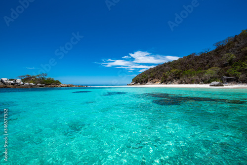 Racha Noi Island on a clear day with clear sea water during the high summer season Phuket Thailand.