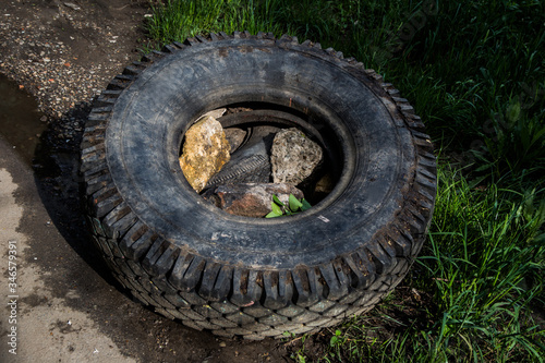  round black car tire lies on the grass