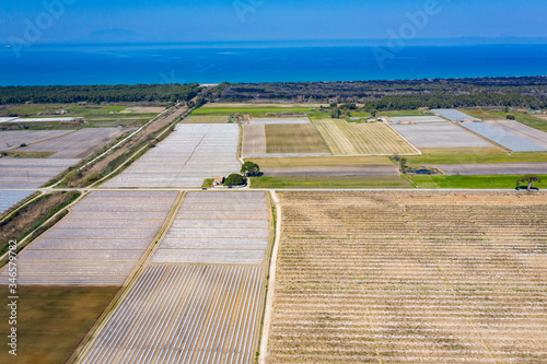 Greenhouses view from above. Long greenhouses for vegetables aerial view. Greece frut farm at Peloponnese