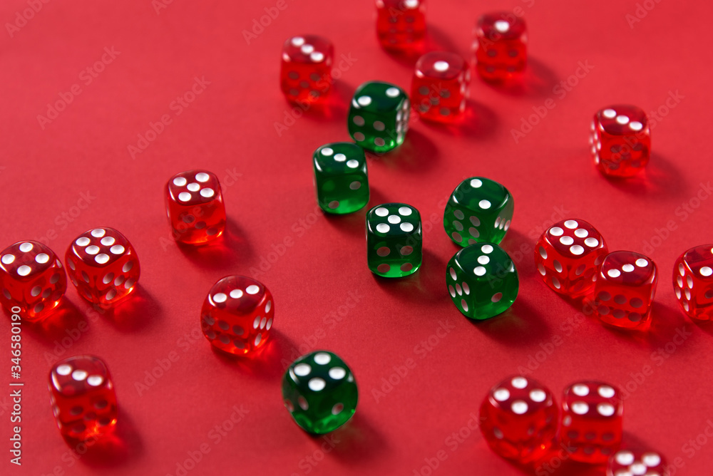 Bright colorful plastic dice on red background Bright colorful plastic dice on red background