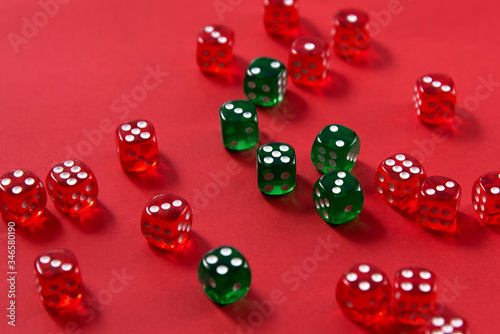 Bright colorful plastic dice on red background