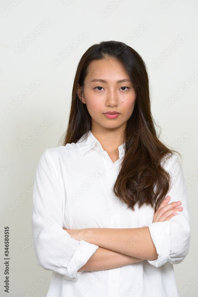 Portrait of young beautiful Asian businesswoman with arms crossed Portrait of young beautiful Asian businesswoman with arms crossed
