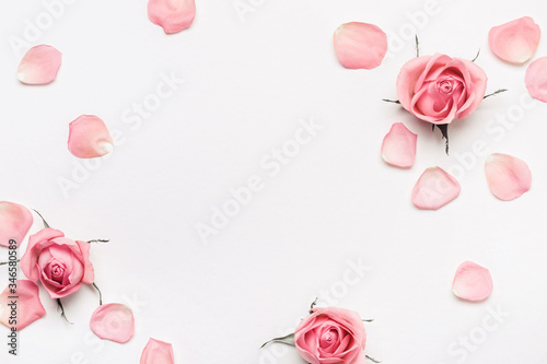 Pastel pink roses frame on white background. Beautiful flower arrangement for your design