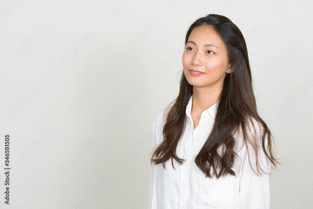 Portrait of young beautiful Asian businesswoman thinking Portrait of young beautiful Asian businesswoman thinking