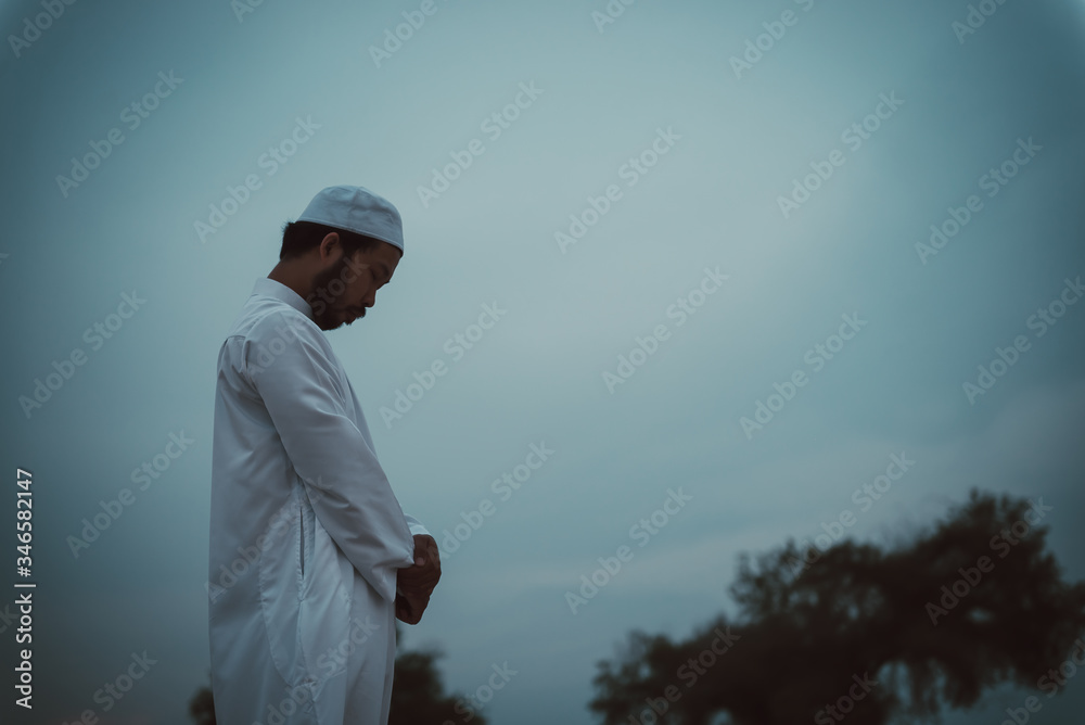 Silhouette Young asian muslim man praying on sunset,Ramadan festival concept Silhouette Young asian muslim man praying on sunset,Ramadan festival concept