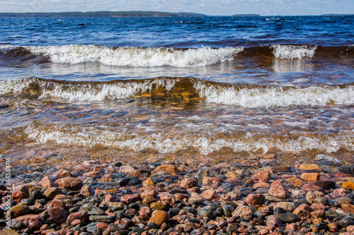 View of the stormy Lake Saimaa and stony shore, Kylaniemi island, Finland photo