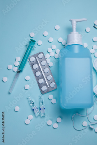 Antivirus concept with pills, sanitizer, syringe