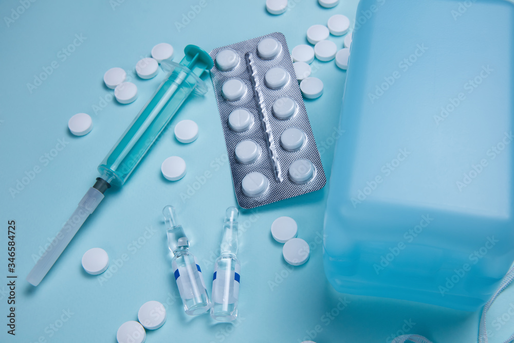 Ampoules with antivirus and syringe on the background of pills Ampoules with antivirus and syringe on the background of pills