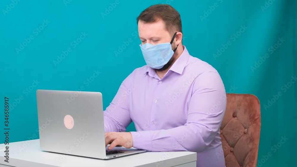 Caucasian adult bearded man works at home. Lifestyle concept photo with copy space. picture with a handsome guy who uses a protective mask. Caucasian adult bearded man works at home. Lifestyle concept photo with copy space. picture with a handsome guy who uses a protective mask.