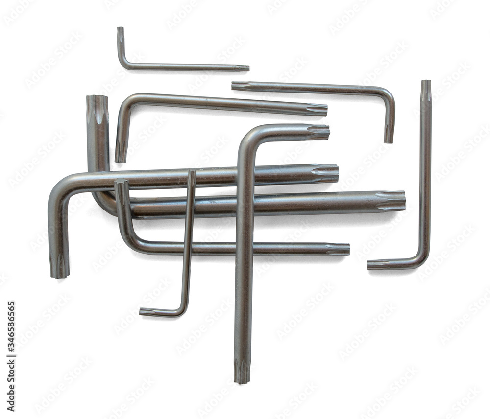 Fototapeta premium A set consisting of a group of nine metal wrenches with a star tip in different sizes from small to large, stacked on top of each other in a composition. Isolated on a white background.