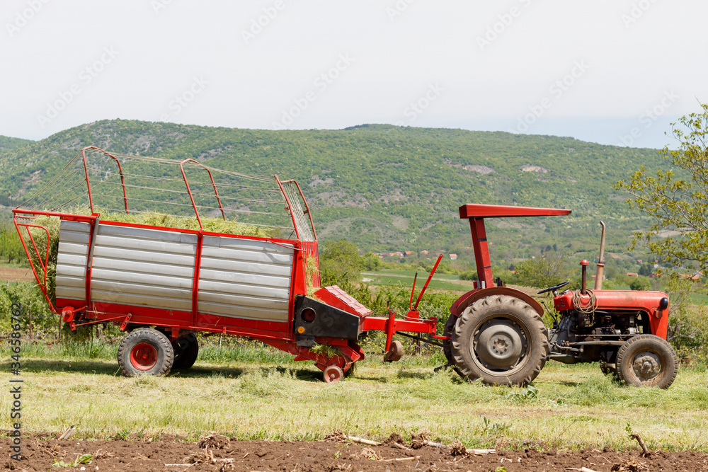 Fototapeta premium Tractor With Hay Collector in The Field