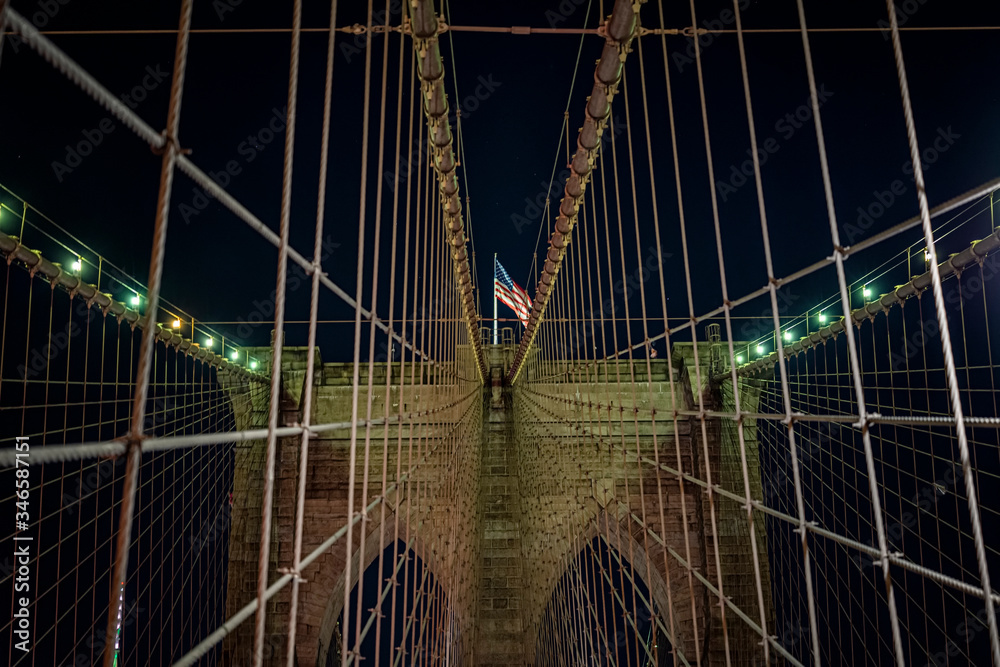 Fototapeta premium Brooklyn bridge during nighttime american flag