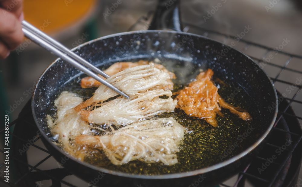 Frying crispy enoki mushroom. Frying crispy enoki mushroom.