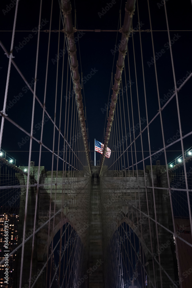 Fototapeta premium Brooklyn bridge during nighttime american flag