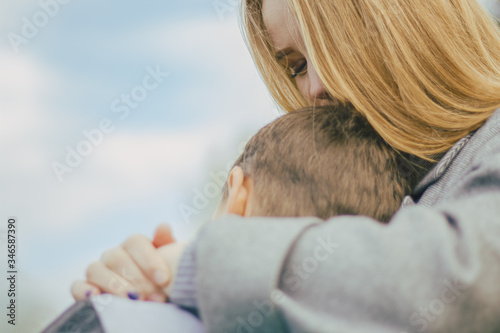An image of a happy mom hugging her son with soft focus.