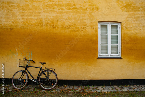 Photography Parked bike in a yellow wall